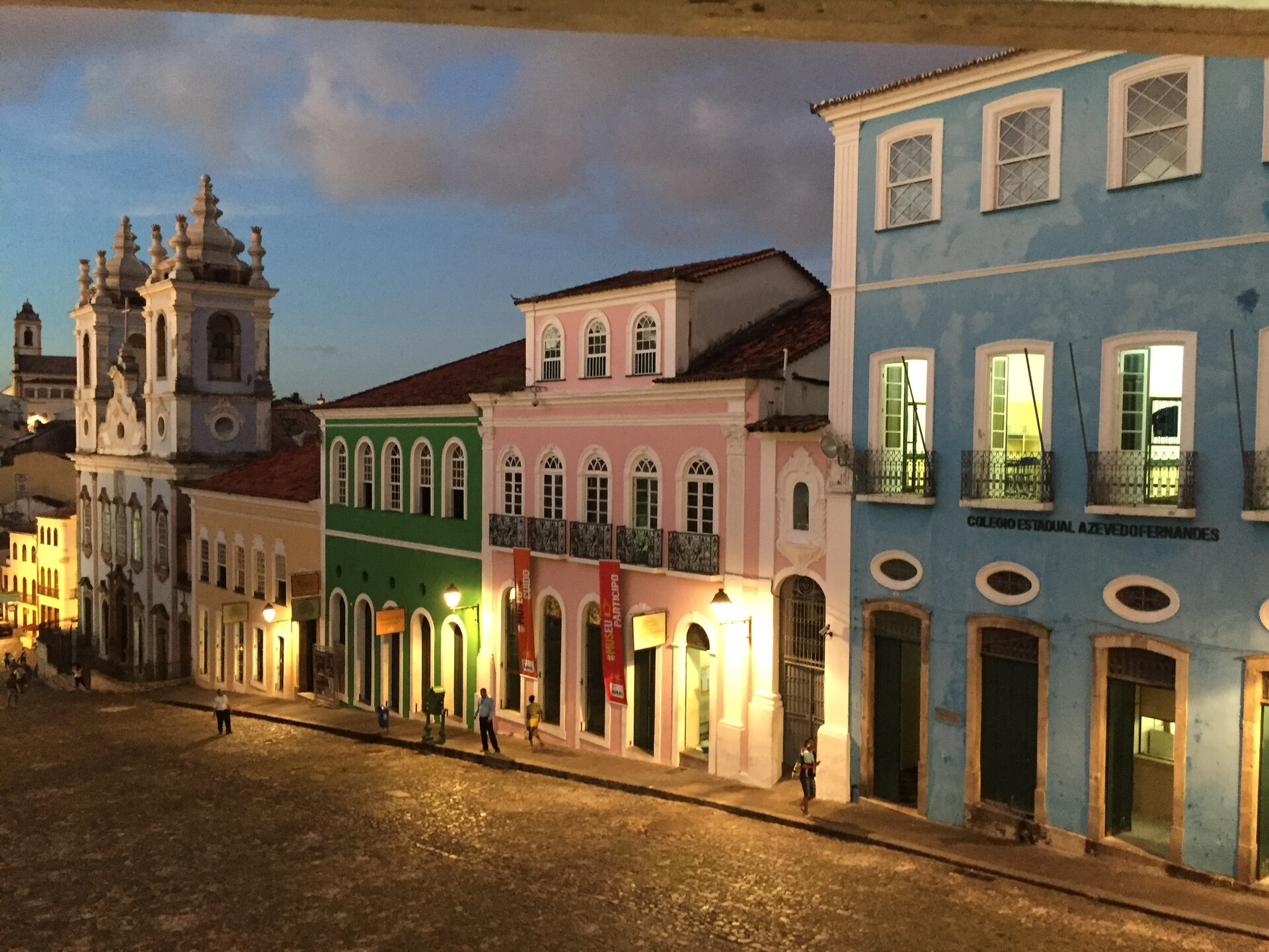 Colorful colonial buildings and a church in Pelourinho, Salvador, at dusk.